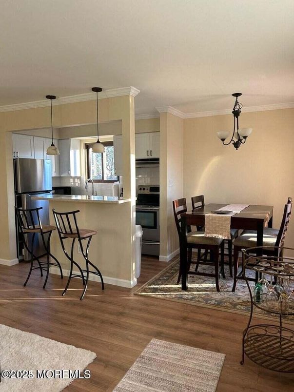 Chandelier, Dining room, Interior, Kitchen, Pendant Lights, Stainless Steel Appliances, Wood Texture Flooring