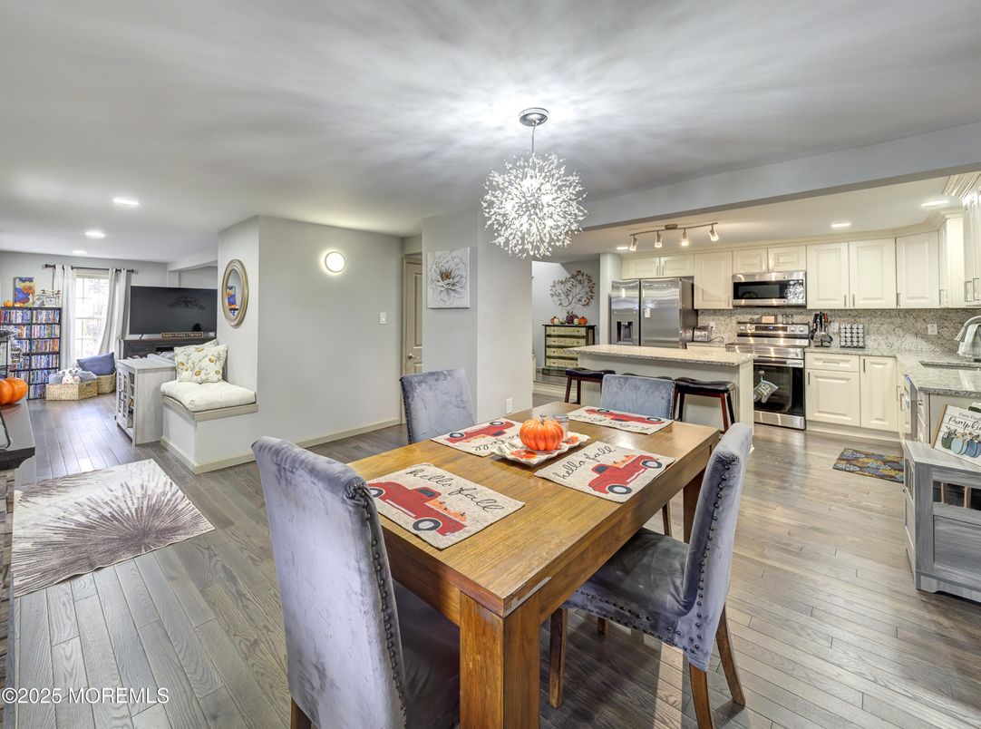 Chandelier, Dining room, Interior, Kitchen, Living room, Recessed Lighting, Stainless Steel Appliances, Wood Texture Flooring