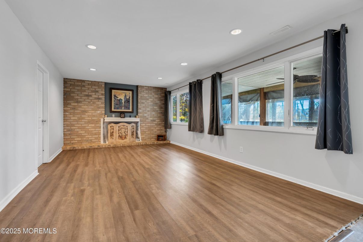 Empty room, Fireplace, Interior, Recessed Lighting, Stone Walls, Wood Texture Flooring