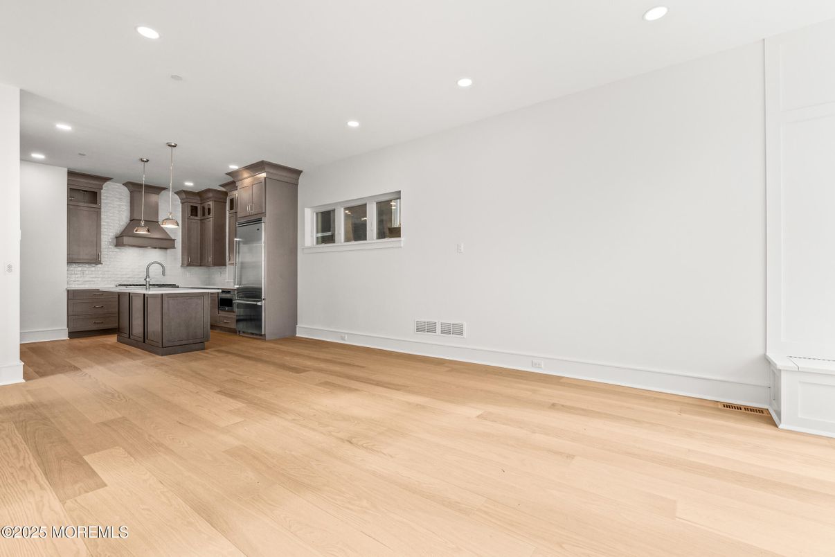 Empty room, Interior, Kitchen, Pendant Lights, Recessed Lighting, Stainless Steel Appliances, Wood Texture Flooring