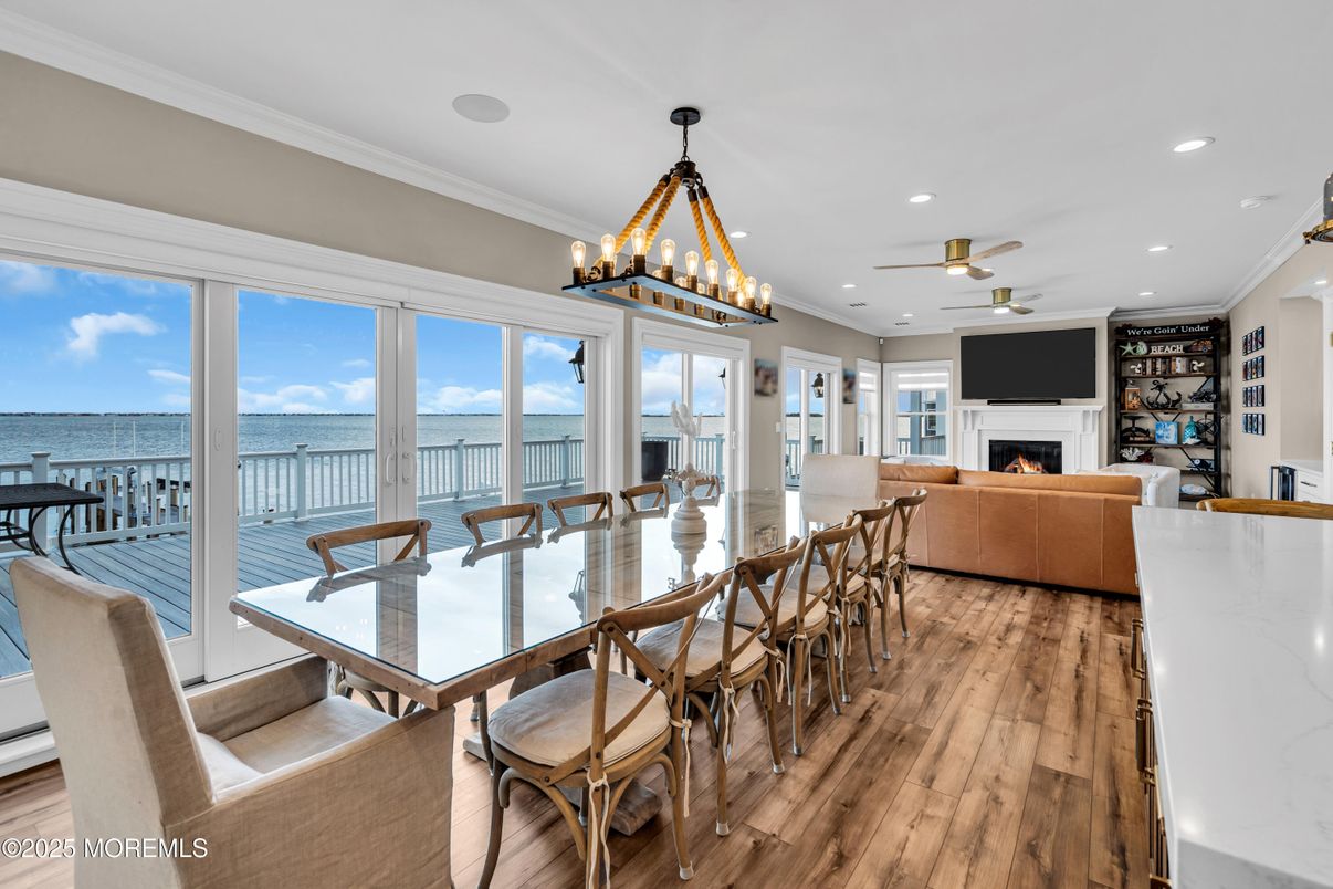 Chandelier, Dining room, Fireplace, Interior, Living room, Pendant Lights, Recessed Lighting, Water, Wood Texture Flooring