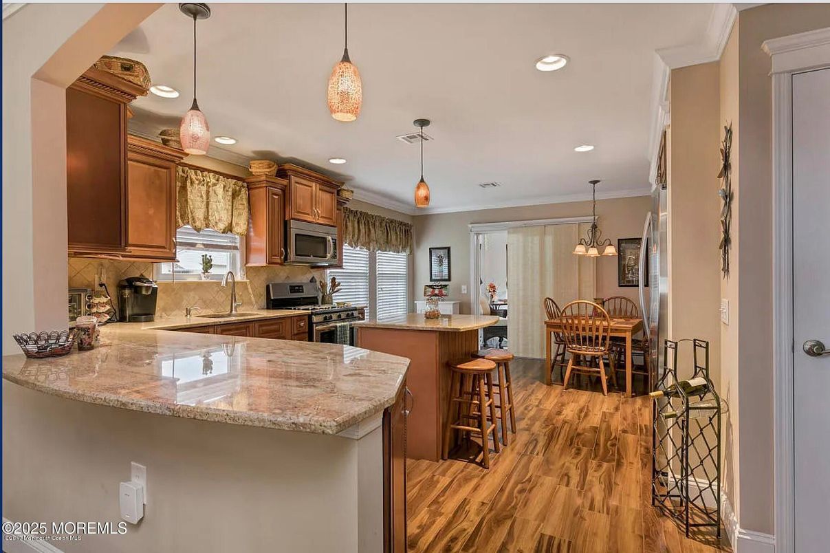 Dining room, Interior, Kitchen, Pendant Lights, Recessed Lighting, Stainless Steel Appliances, Wood Texture Flooring