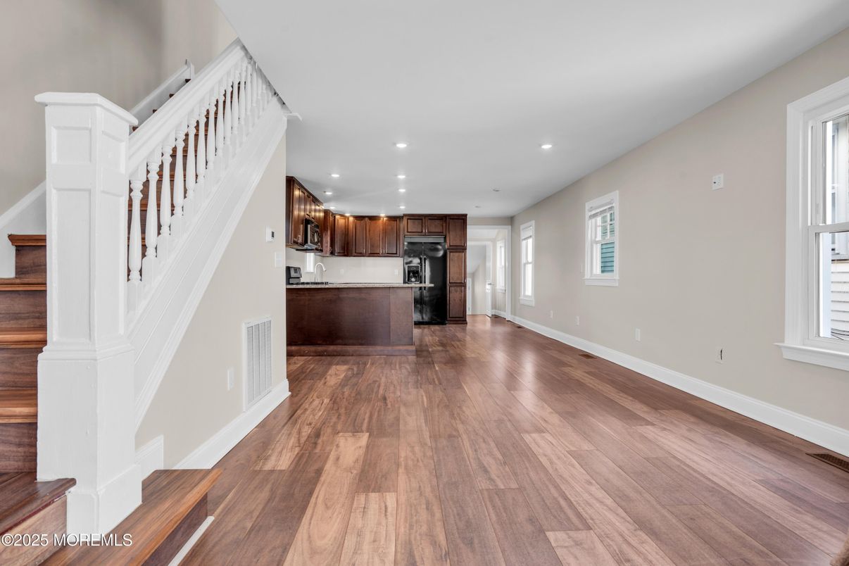 Empty room, Interior, Kitchen, Recessed Lighting, Stainless Steel Appliances, Wood Texture Flooring