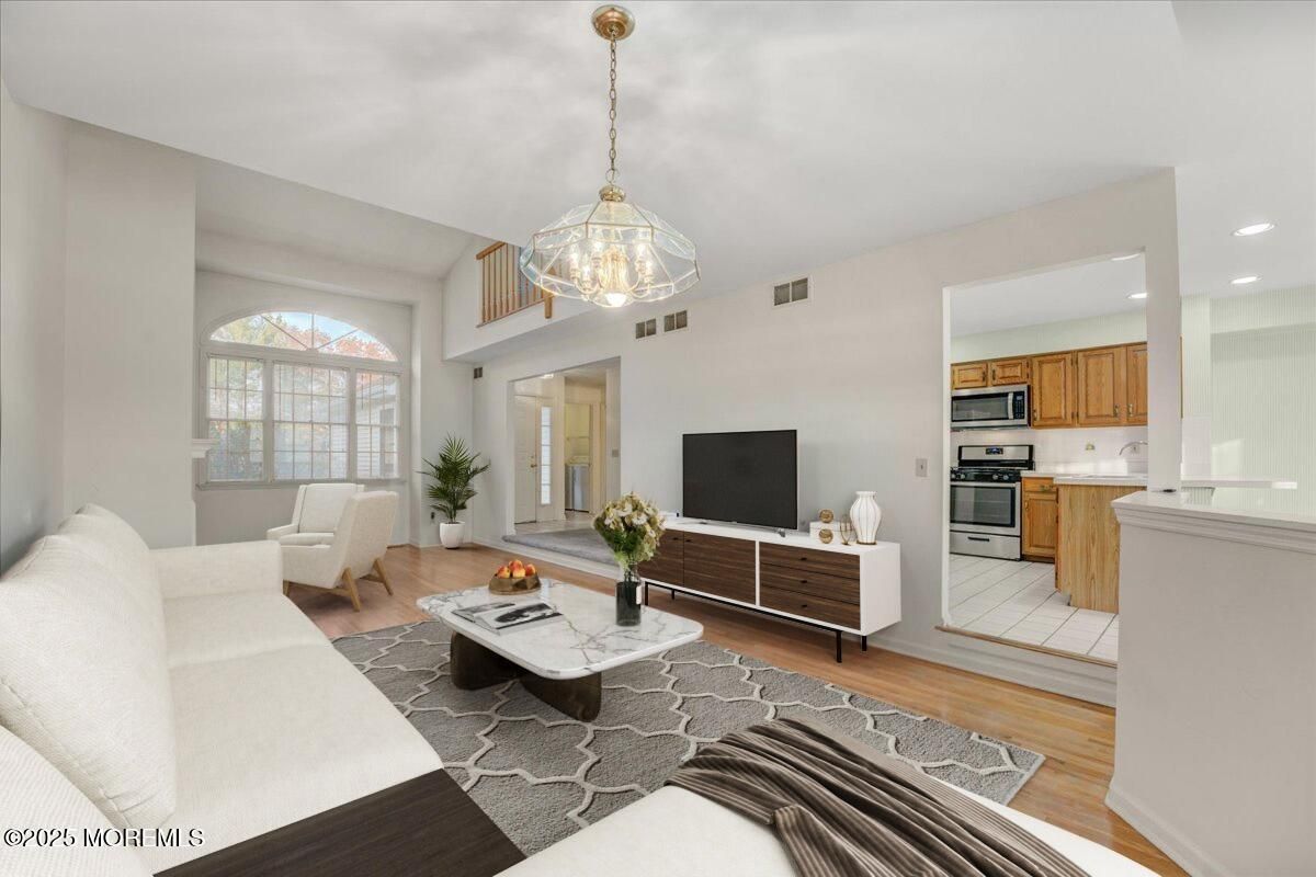 Chandelier, Interior, Kitchen, Living room, Pendant Lights, Recessed Lighting, Stainless Steel Appliances, Wood Texture Flooring