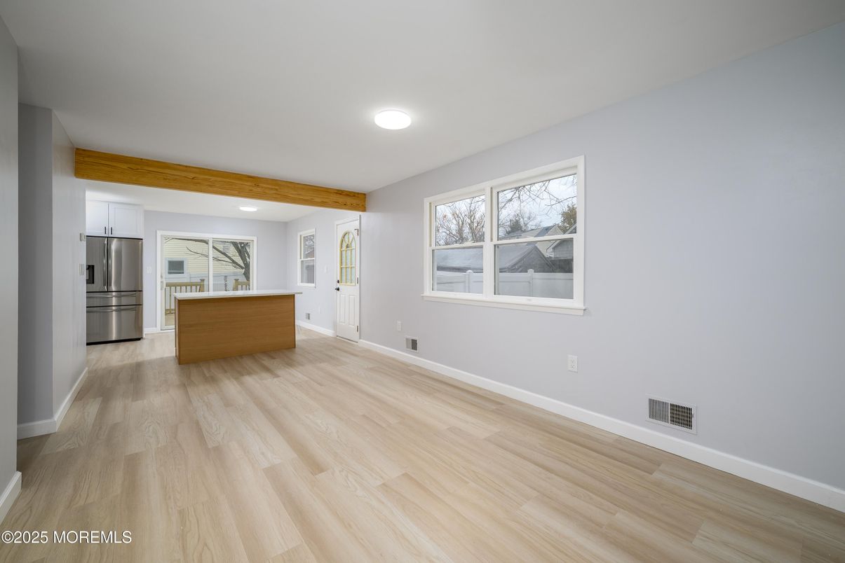 Empty room, Interior, Kitchen, Recessed Lighting, Stainless Steel Appliances, Wood Texture Flooring