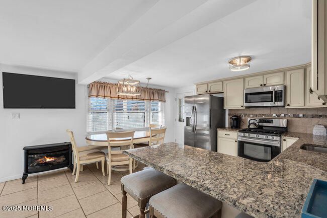 Dining room, Fireplace, Interior, Kitchen, Pendant Lights, Stainless Steel Appliances