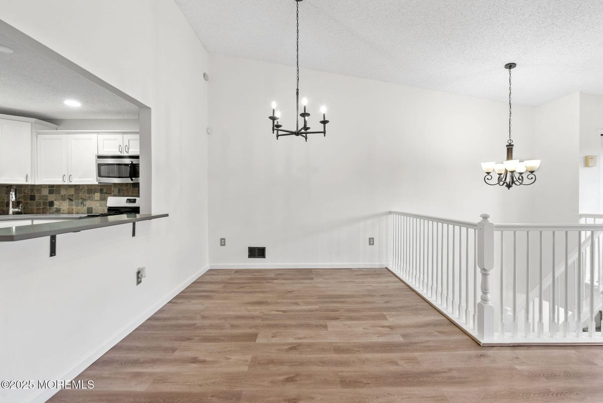 Chandelier, Empty room, Interior, Kitchen, Recessed Lighting, Stainless Steel Appliances, Wood Texture Flooring