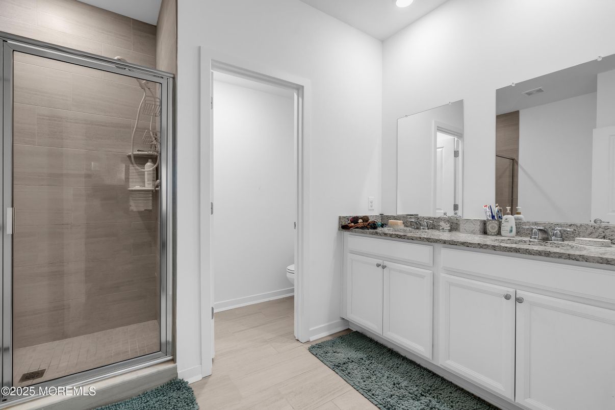 Bathroom, Dual Sink Vanities, Glass Shower, Interior, Recessed Lighting, Wood Texture Flooring