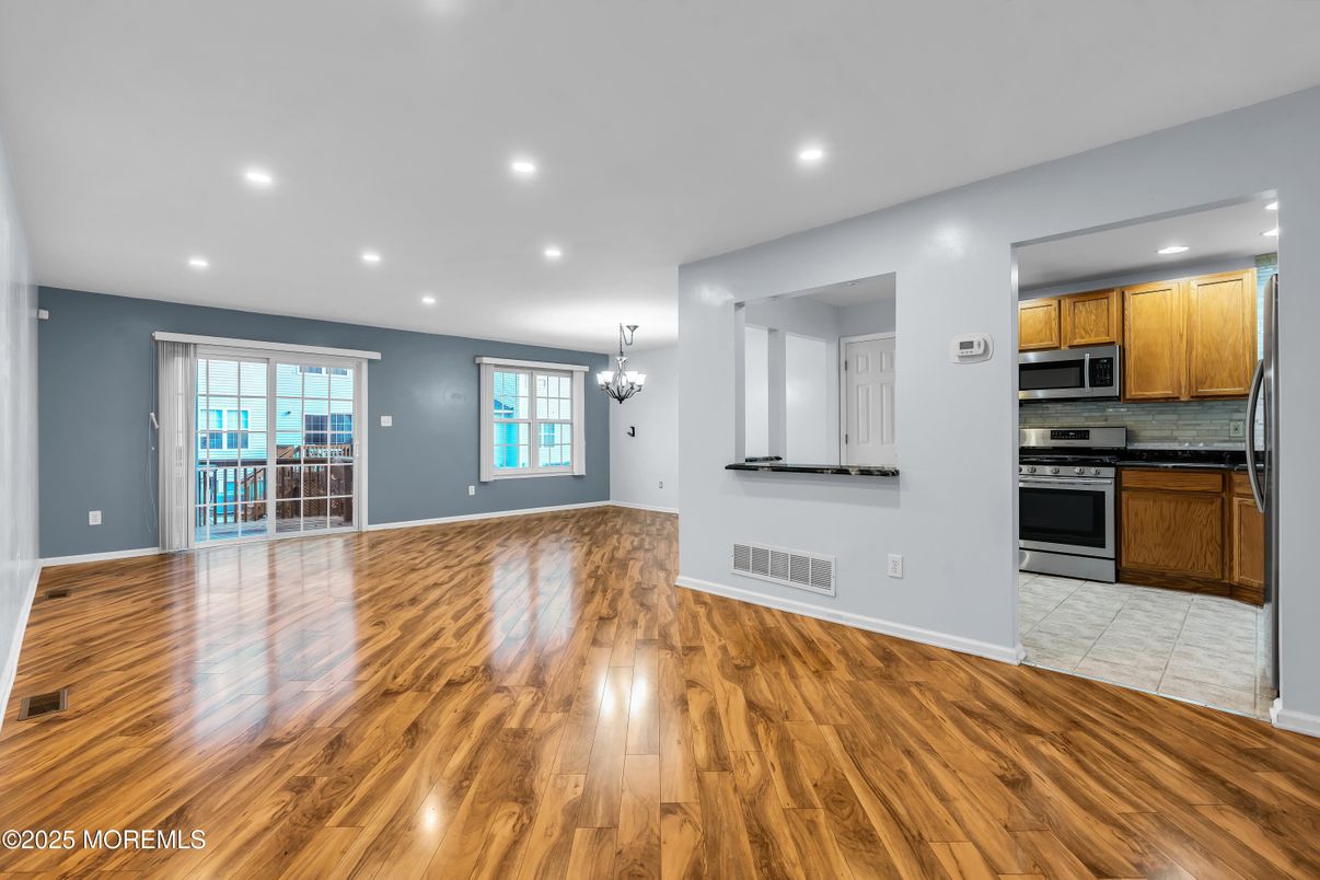 Chandelier, Empty room, Interior, Kitchen, Recessed Lighting, Stainless Steel Appliances, Wood Texture Flooring
