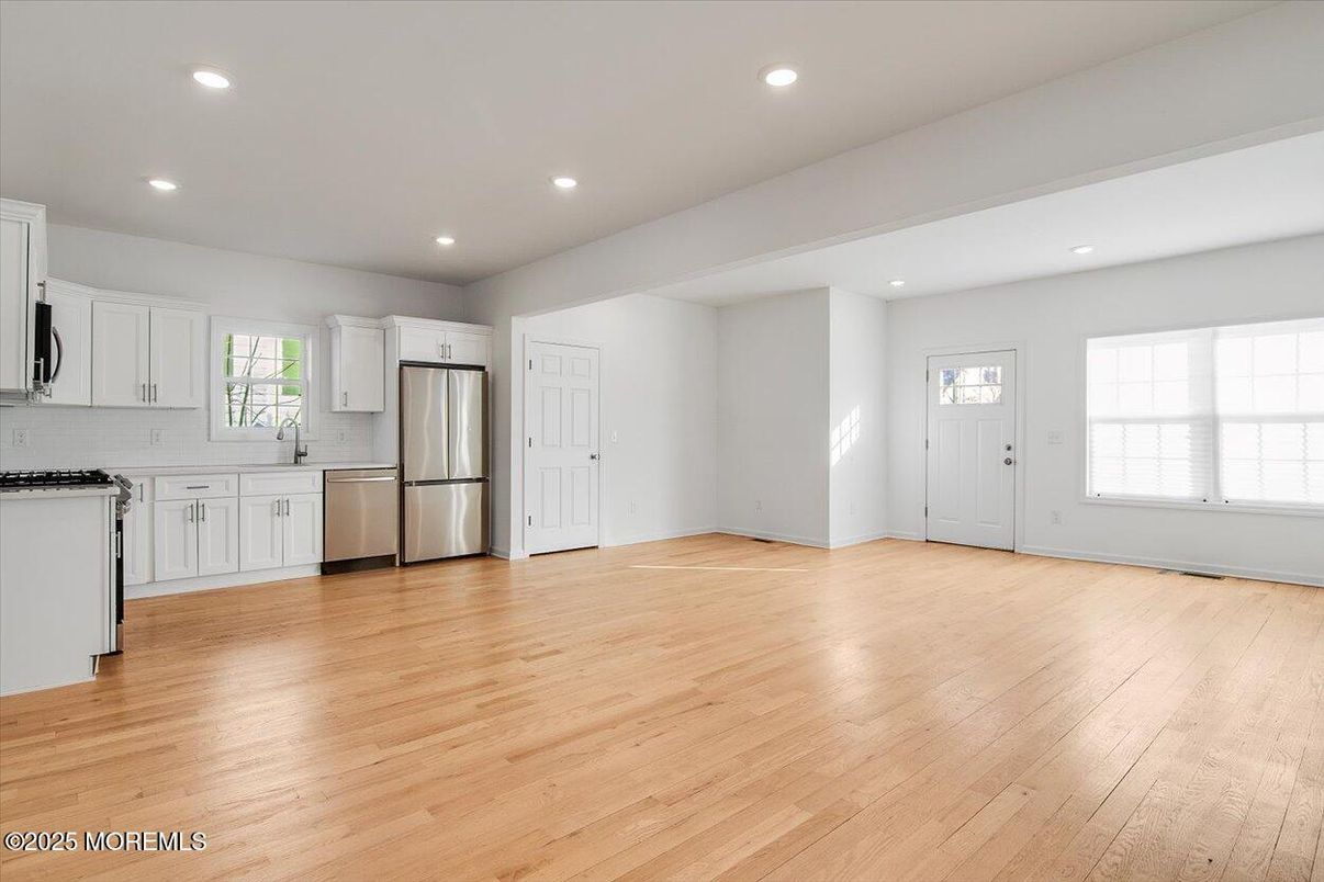 Empty room, Interior, Kitchen, Recessed Lighting, Stainless Steel Appliances, Wood Texture Flooring