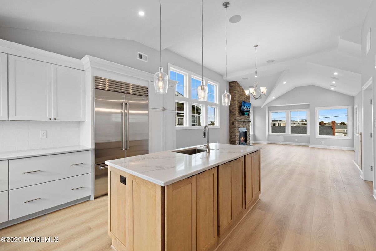 Chandelier, Fireplace, Interior, Kitchen, Pendant Lights, Recessed Lighting, Stainless Steel Appliances, Wood Texture Flooring