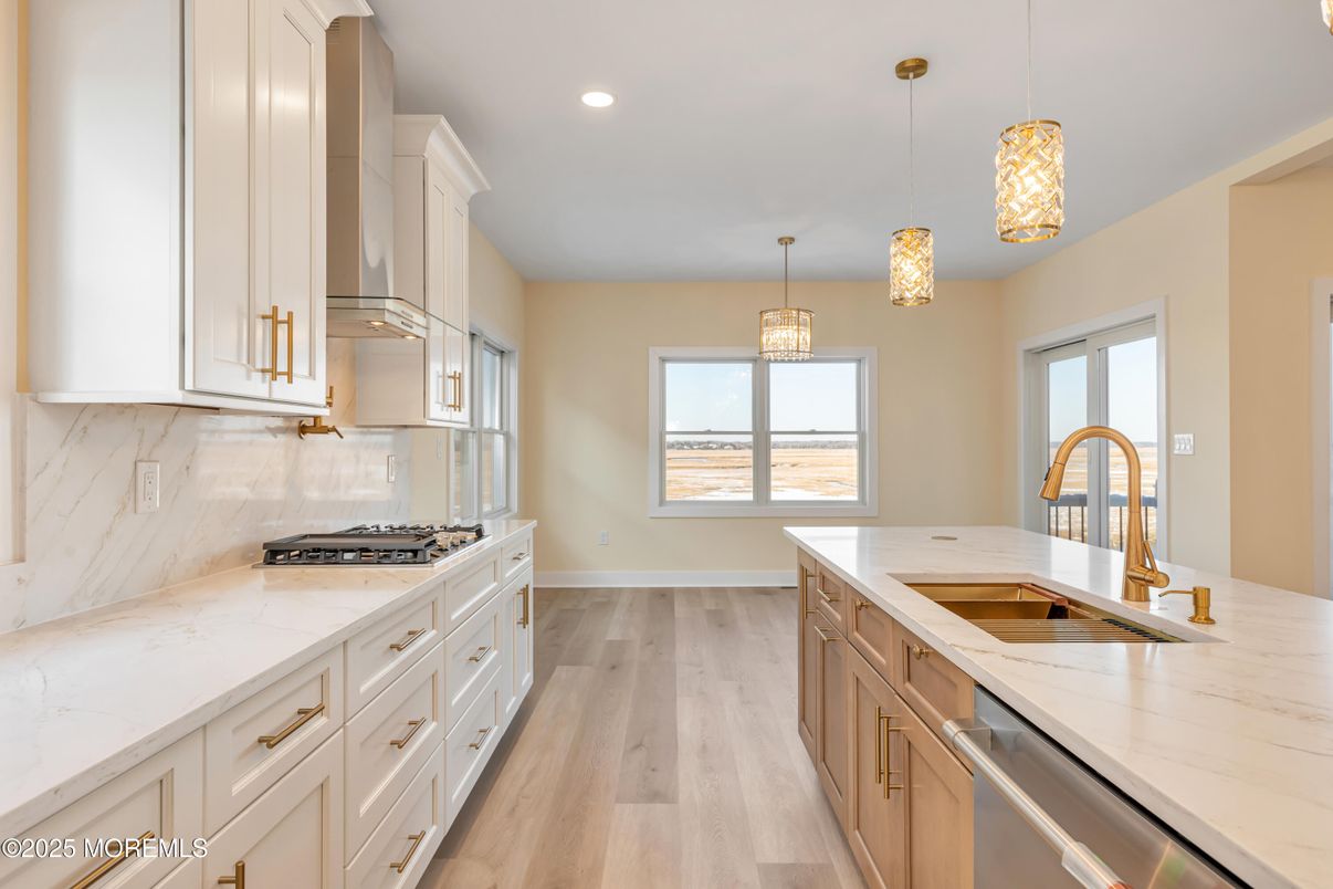 Chandelier, Interior, Kitchen, Marble Walls, Pendant Lights, Recessed Lighting, Stainless Steel Appliances, Wood Texture Flooring