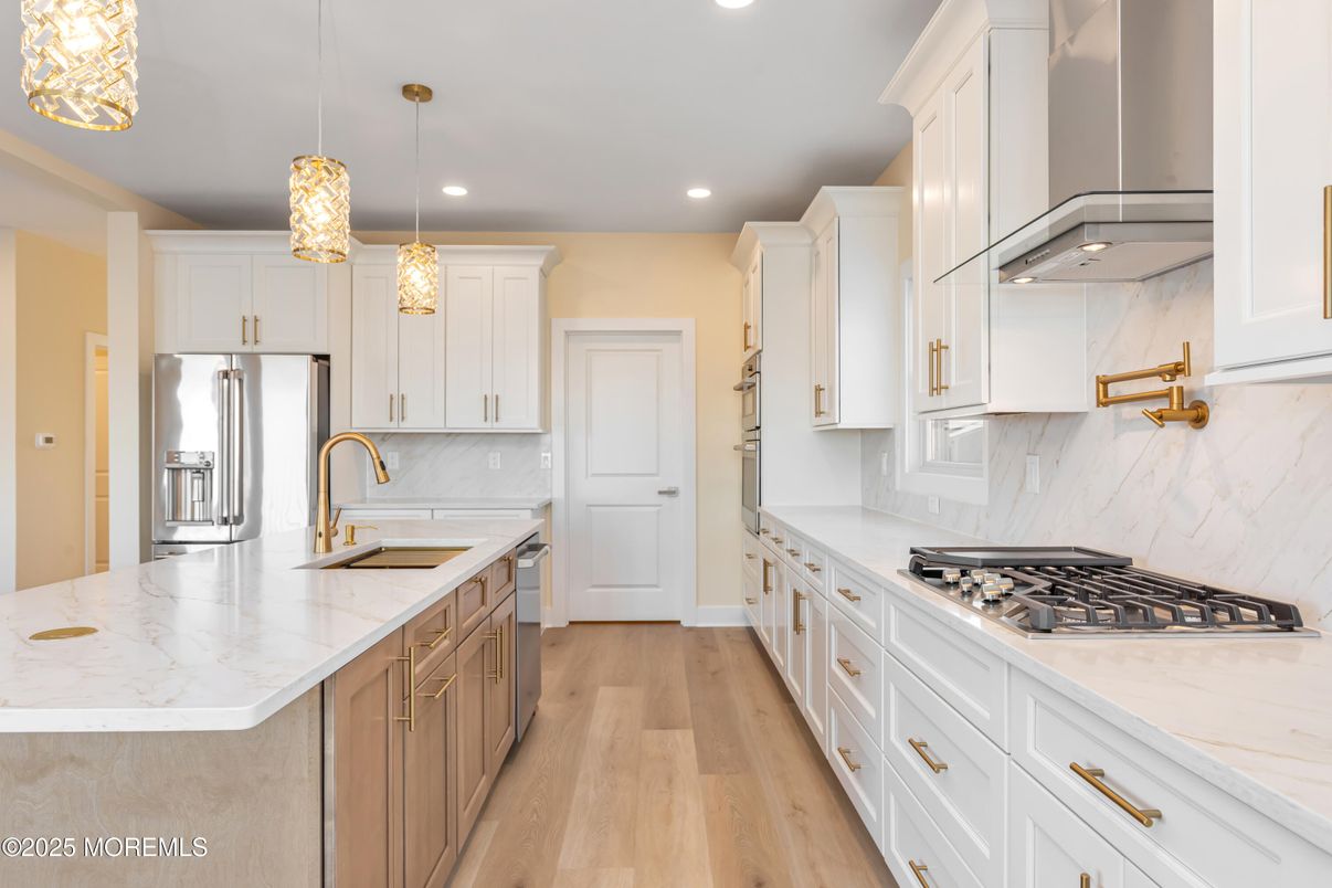 Interior, Kitchen, Marble Walls, Pendant Lights, Recessed Lighting, Stainless Steel Appliances, Wood Texture Flooring