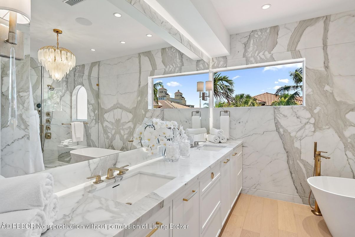 Bathroom, Chandelier, Dual Sink Vanities, Free Standing Baths, Glass Shower, Interior, Marble Walls, Recessed Lighting, Wood Texture Flooring