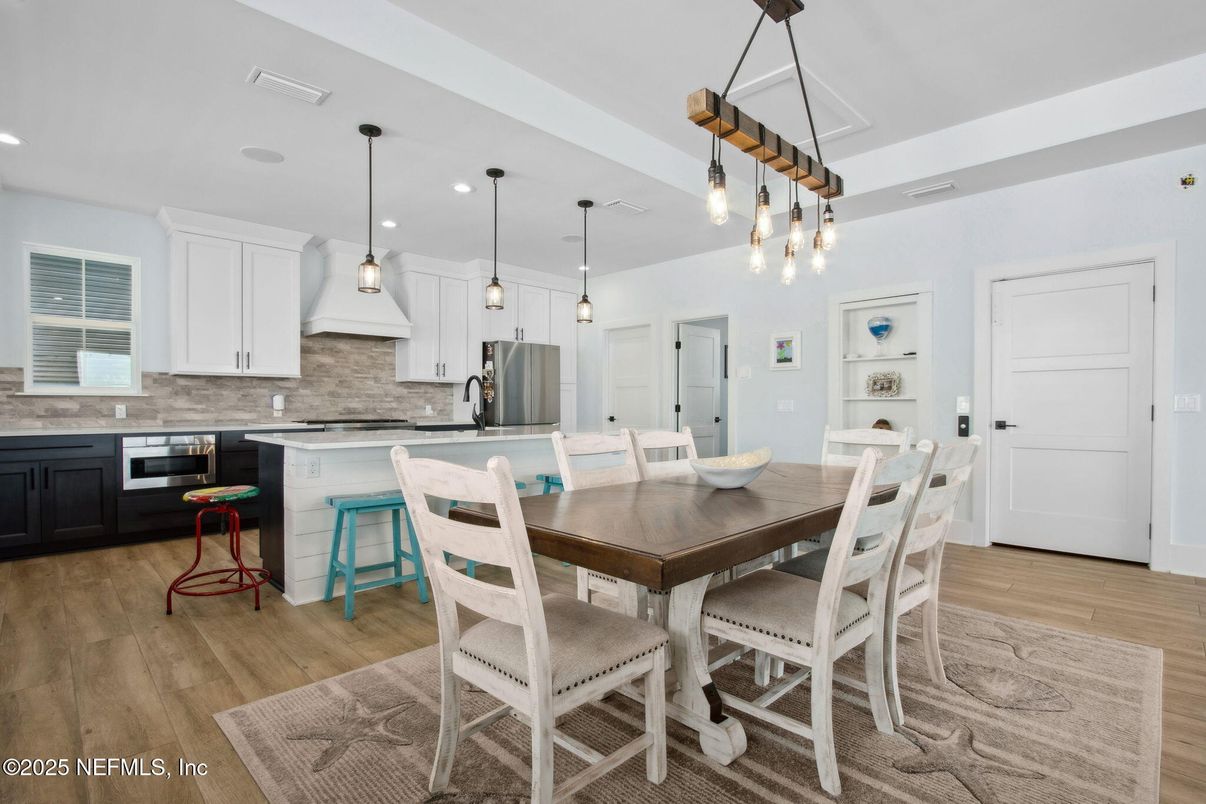Dining room, Interior, Kitchen, Pendant Lights, Recessed Lighting, Stainless Steel Appliances, Wood Texture Flooring
