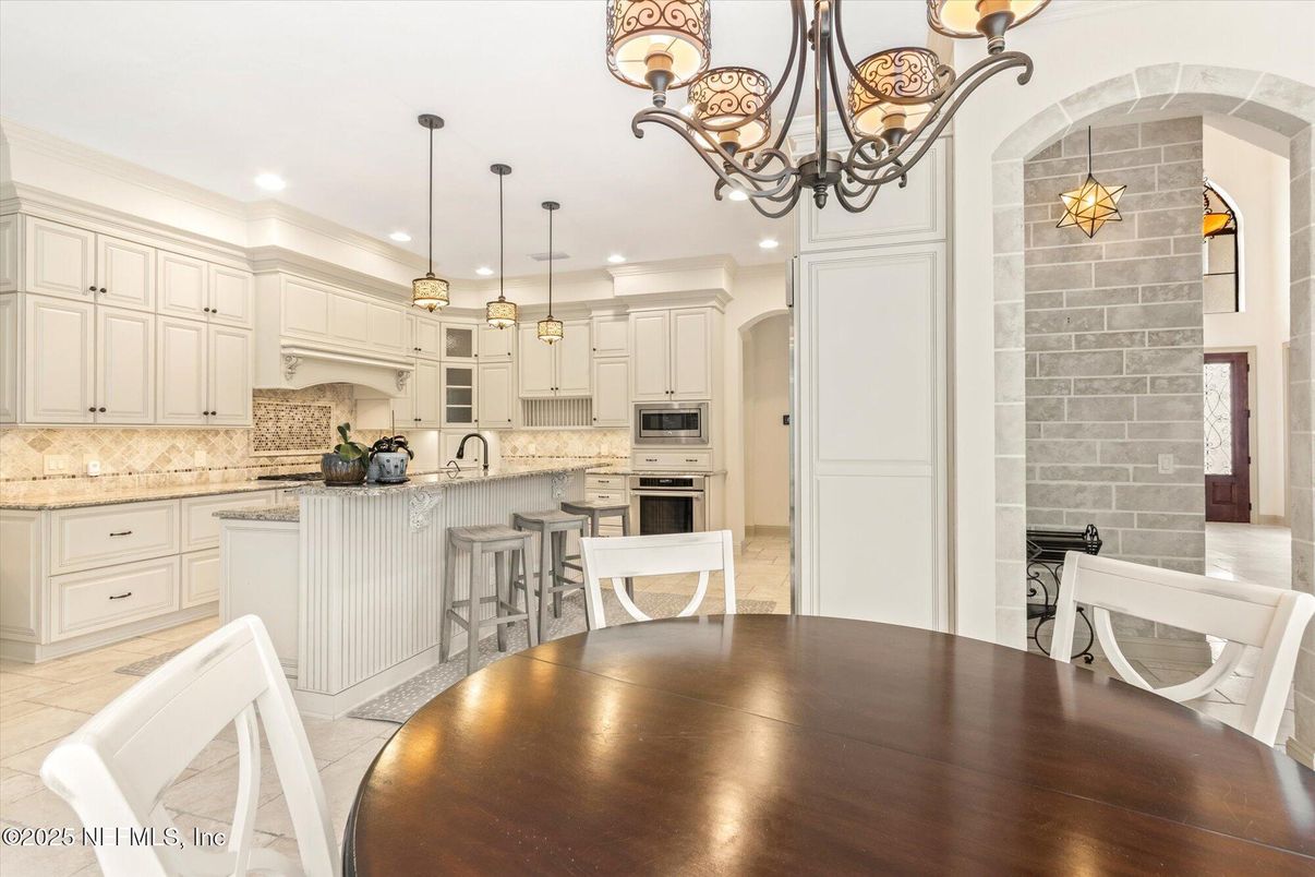 Chandelier, Dining room, Interior, Kitchen, Pendant Lights, Recessed Lighting, Stainless Steel Appliances, Stone Walls, Wood Texture Flooring