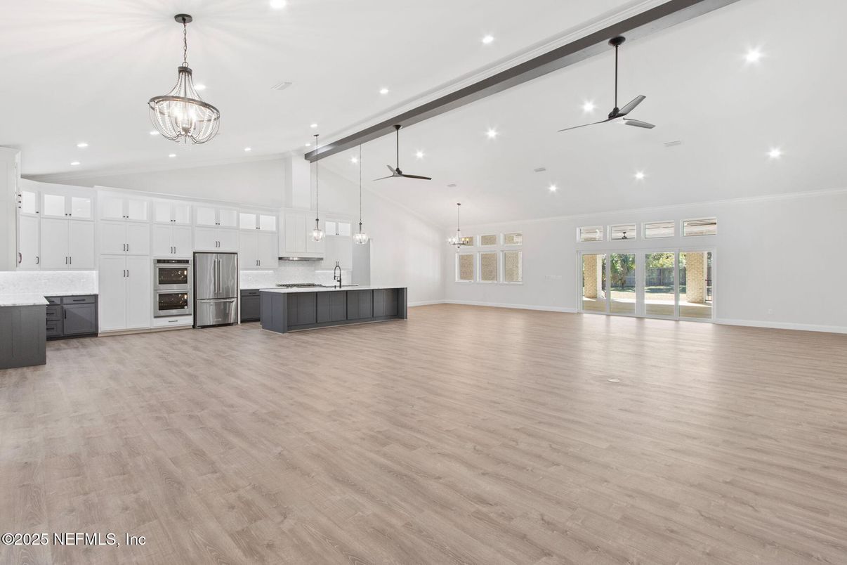 Chandelier, Empty room, Interior, Kitchen, Pendant Lights, Recessed Lighting, Stainless Steel Appliances, Wood Texture Flooring