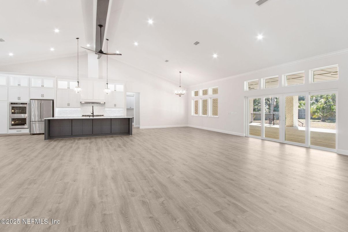 Chandelier, Empty room, Interior, Kitchen, Pendant Lights, Recessed Lighting, Stainless Steel Appliances, Wood Texture Flooring