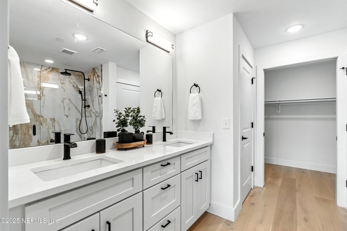 Bathroom, Dual Sink Vanities, Glass Shower, Interior, Marble Walls, Recessed Lighting, Wood Texture Flooring