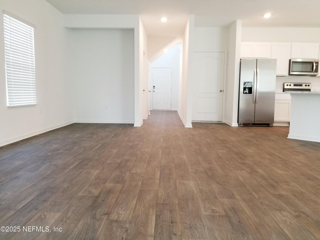 Empty room, Interior, Kitchen, Recessed Lighting, Stainless Steel Appliances, Wood Texture Flooring