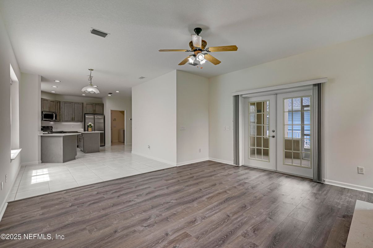 Empty room, Interior, Kitchen, Pendant Lights, Recessed Lighting, Stainless Steel Appliances, Wood Texture Flooring