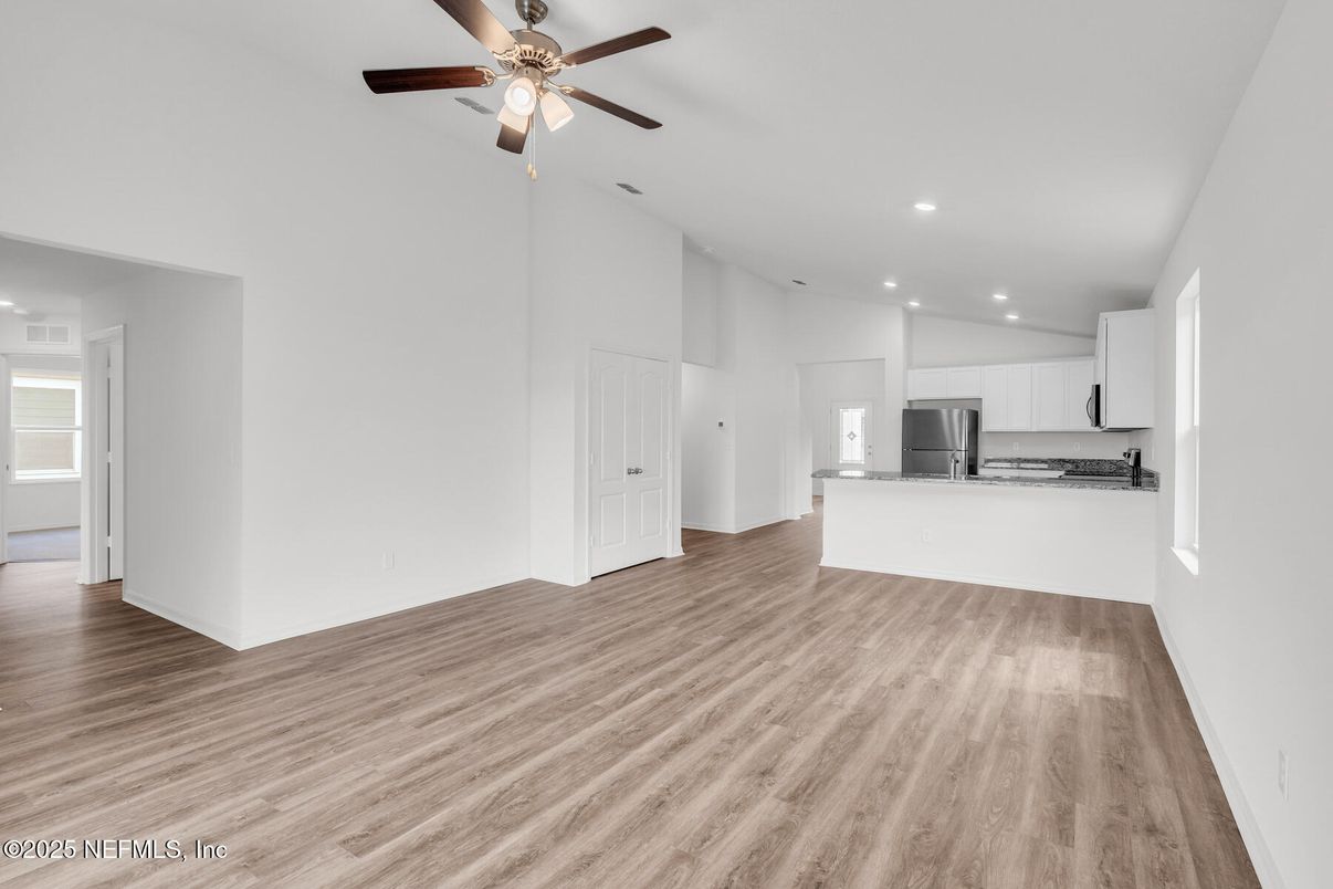 Empty room, Interior, Kitchen, Recessed Lighting, Stainless Steel Appliances, Wood Texture Flooring