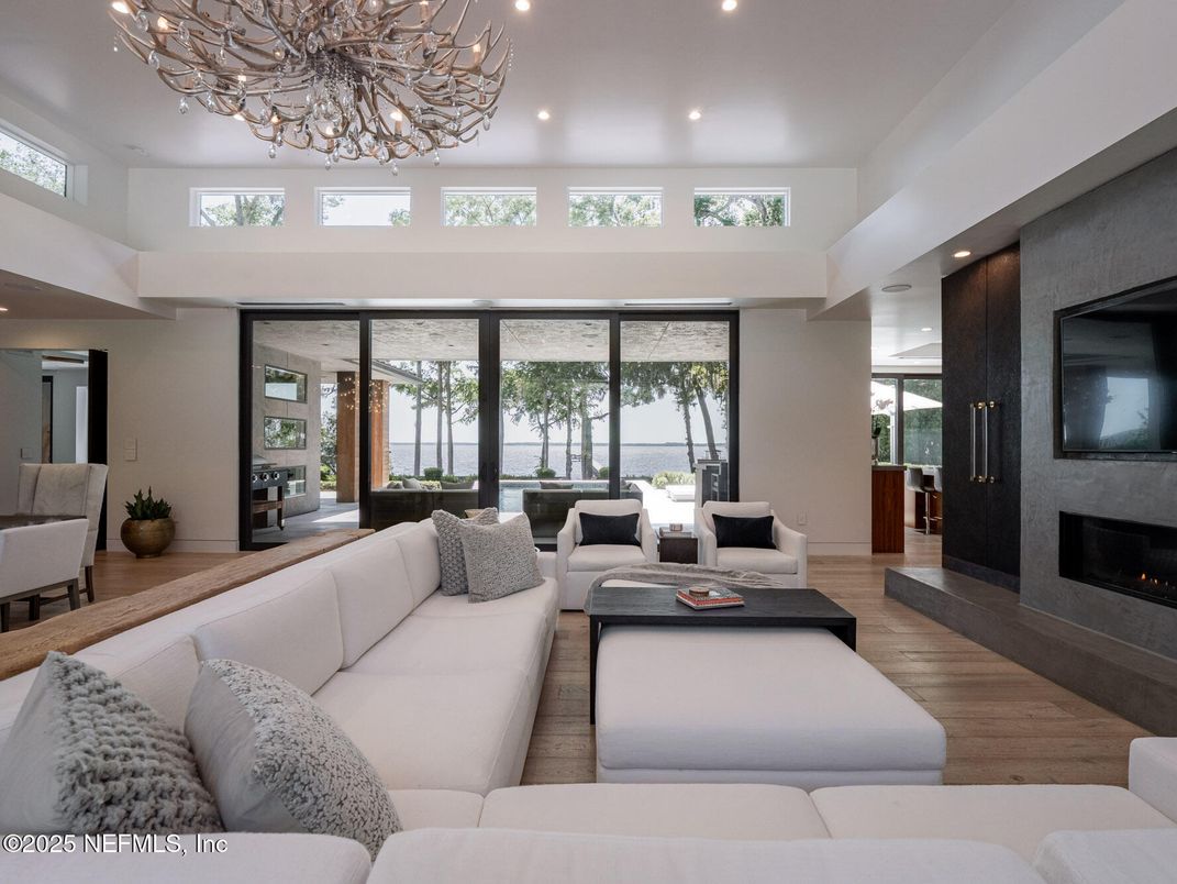 Chandelier, Fireplace, Interior, Living room, Recessed Lighting, Water, Wood Texture Flooring