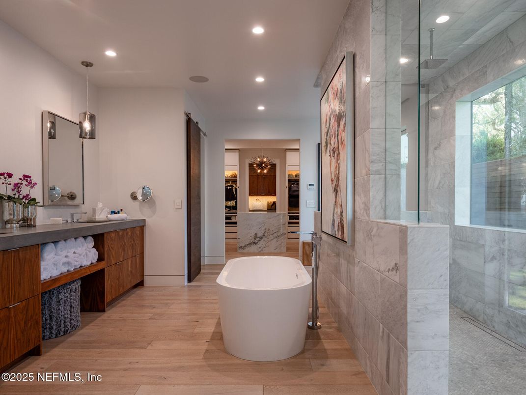 Bathroom, Dual Sink Vanities, Free Standing Baths, Glass Shower, Interior, Marble Walls, Pendant Lights, Recessed Lighting, Wood Texture Flooring