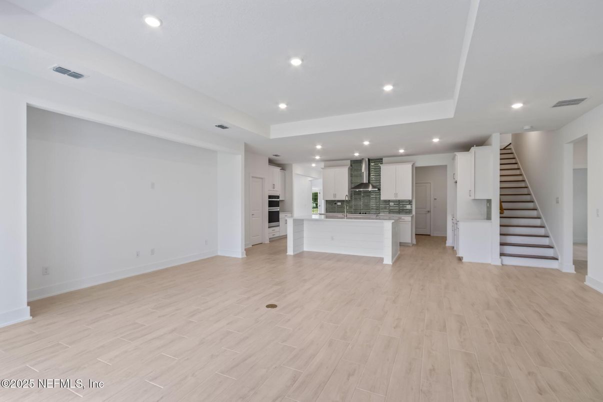 Empty room, Interior, Kitchen, Recessed Lighting, Stainless Steel Appliances, Wood Texture Flooring