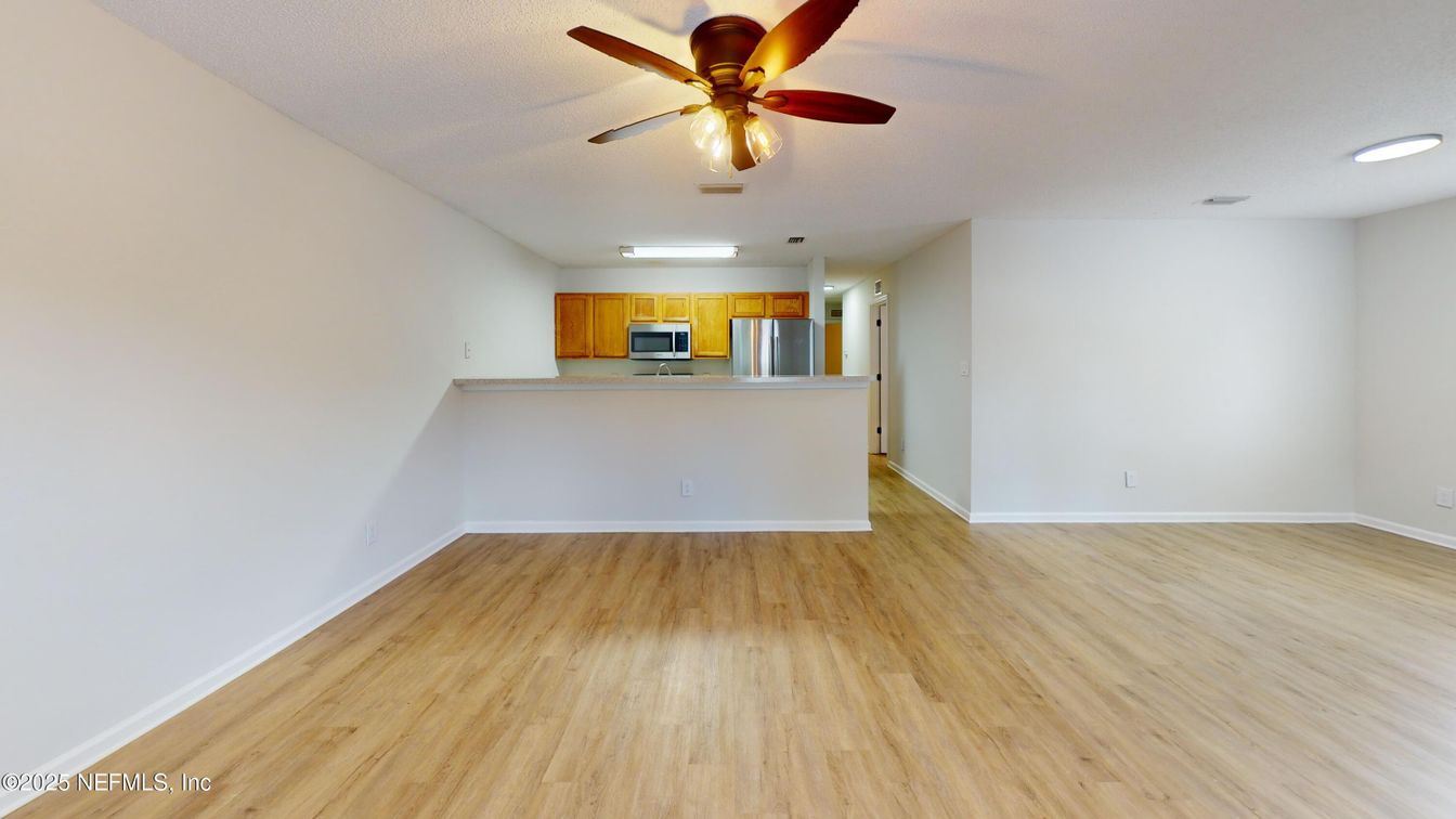 Empty room, Interior, Kitchen, Recessed Lighting, Stainless Steel Appliances, Wood Texture Flooring