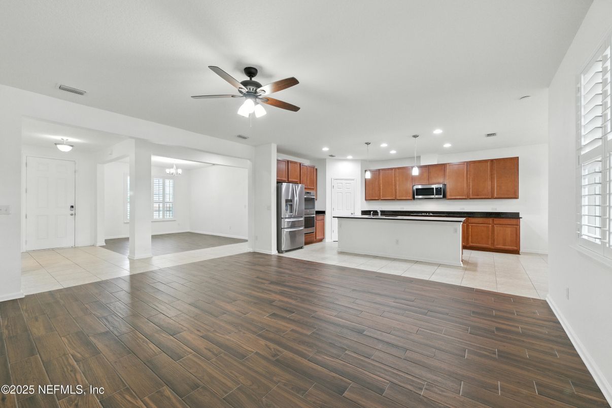 Empty room, Interior, Kitchen, Recessed Lighting, Stainless Steel Appliances, Wood Texture Flooring