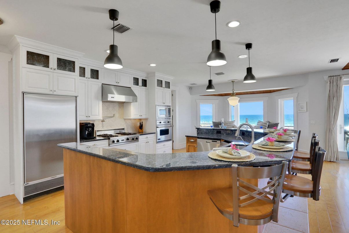 Dining room, Interior, Kitchen, Pendant Lights, Recessed Lighting, Stainless Steel Appliances, Water, Wood Texture Flooring