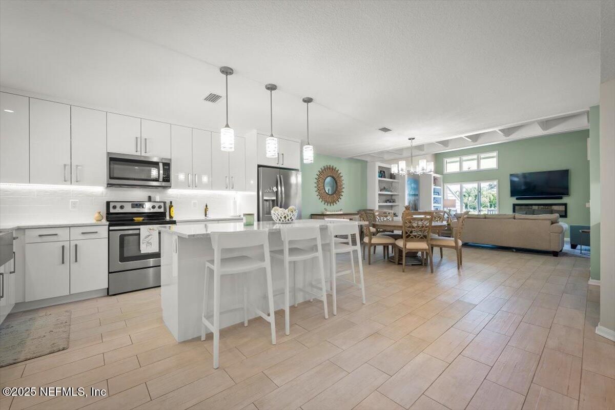 Chandelier, Dining room, Interior, Kitchen, Living room, Pendant Lights, Stainless Steel Appliances, Wood Texture Flooring