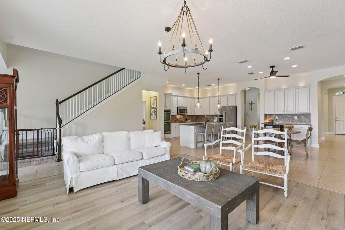 Chandelier, Dining room, Interior, Kitchen, Living room, Pendant Lights, Recessed Lighting, Stainless Steel Appliances, Wood Texture Flooring