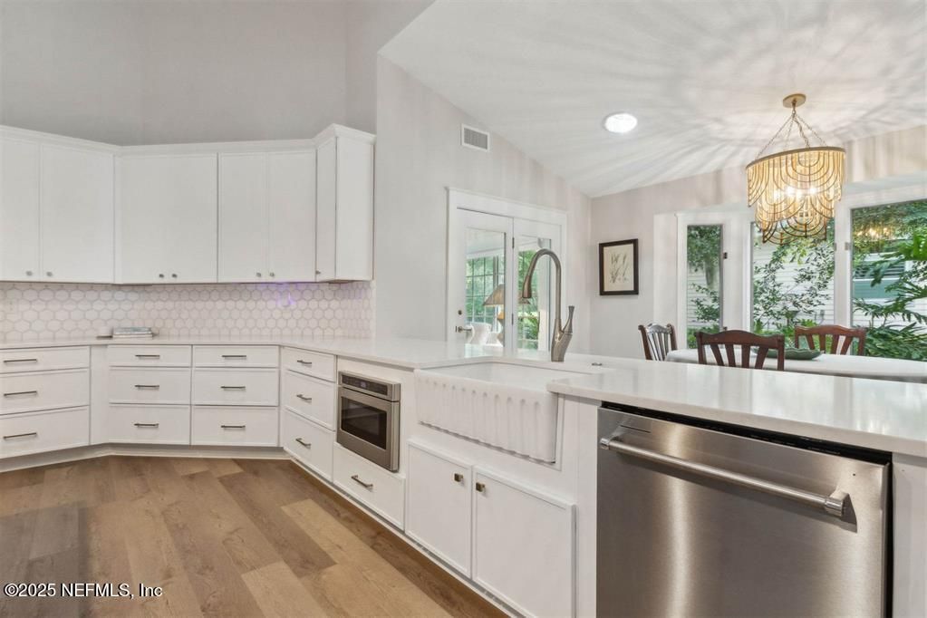 Chandelier, Dining room, Interior, Kitchen, Recessed Lighting, Stainless Steel Appliances, Wood Texture Flooring