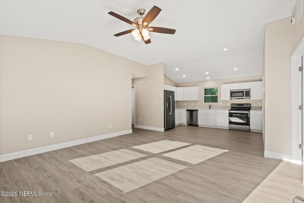 Empty room, Interior, Kitchen, Recessed Lighting, Stainless Steel Appliances, Wood Texture Flooring