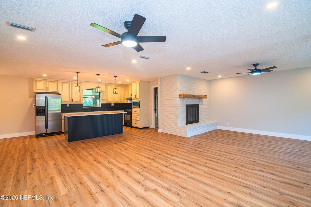 Fireplace, Interior, Kitchen, Pendant Lights, Recessed Lighting, Stainless Steel Appliances, Wood Texture Flooring