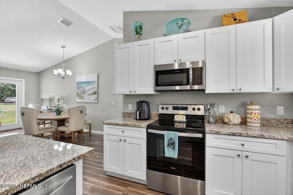 Chandelier, Dining room, Interior, Kitchen, Pendant Lights, Stainless Steel Appliances, Wood Texture Flooring
