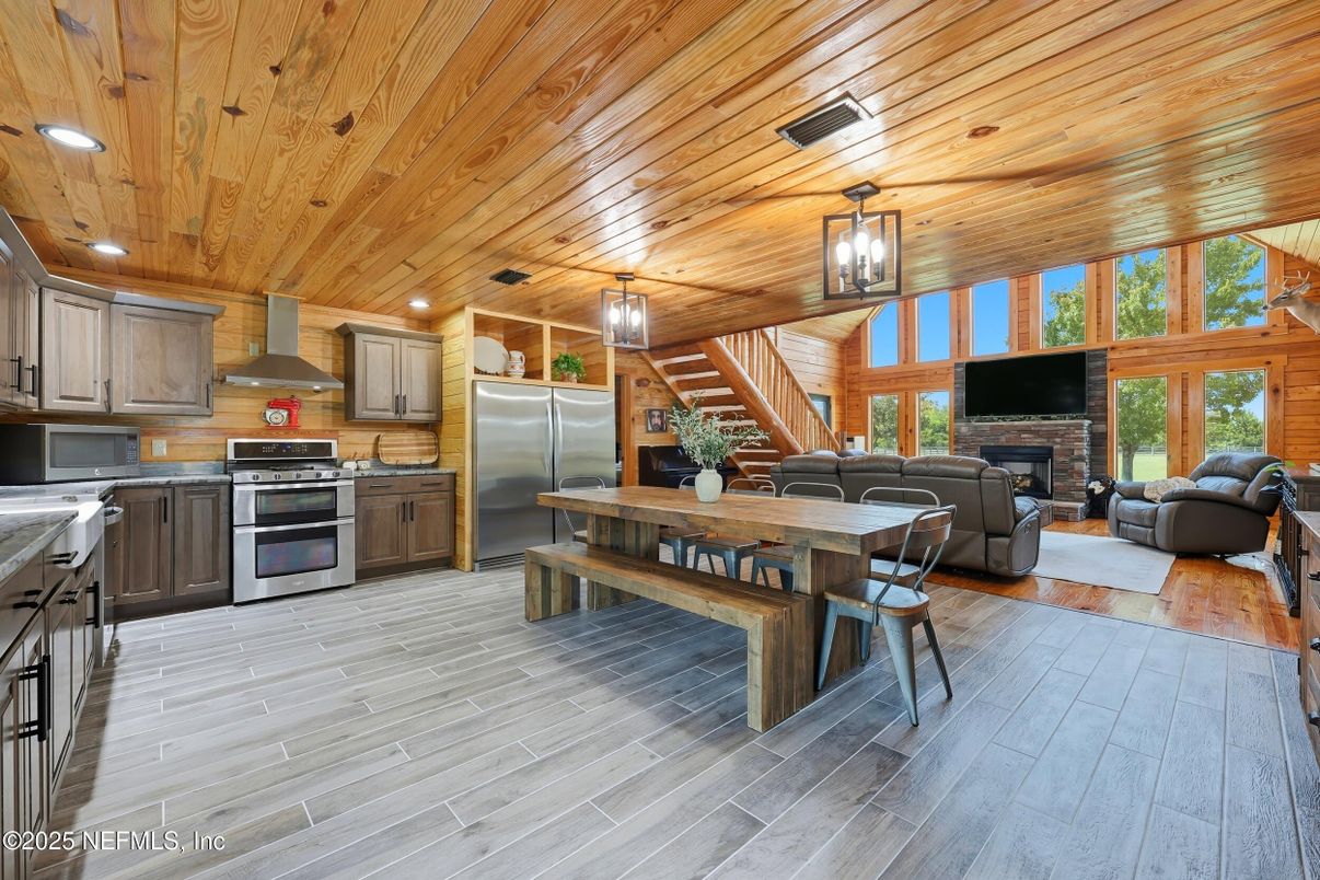 Dining room, Fireplace, Interior, Kitchen, Living room, Recessed Lighting, Stainless Steel Appliances, Wooden Ceilings, Wood Texture Flooring