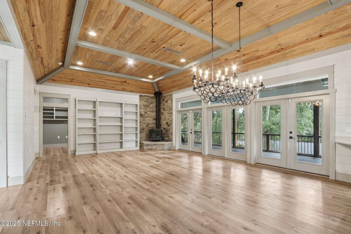 Chandelier, Empty room, Fireplace, Interior, Recessed Lighting, Stone Walls, Wooden Beams, Wooden Ceilings, Wood Texture Flooring
