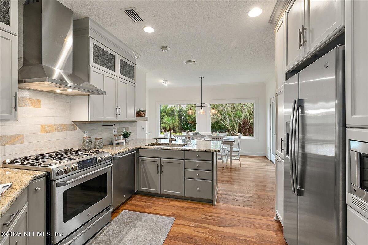 Dining room, Interior, Kitchen, Pendant Lights, Recessed Lighting, Stainless Steel Appliances, Wood Texture Flooring