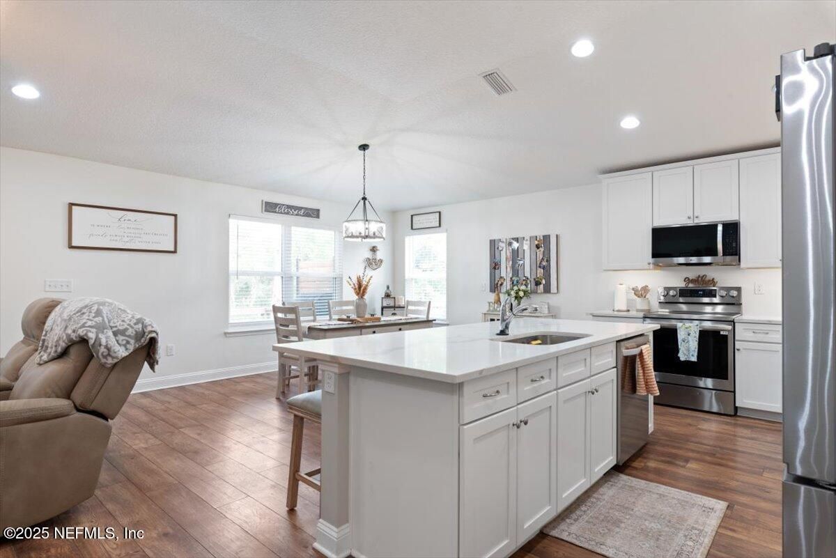 Chandelier, Dining room, Interior, Kitchen, Pendant Lights, Recessed Lighting, Stainless Steel Appliances, Wood Texture Flooring
