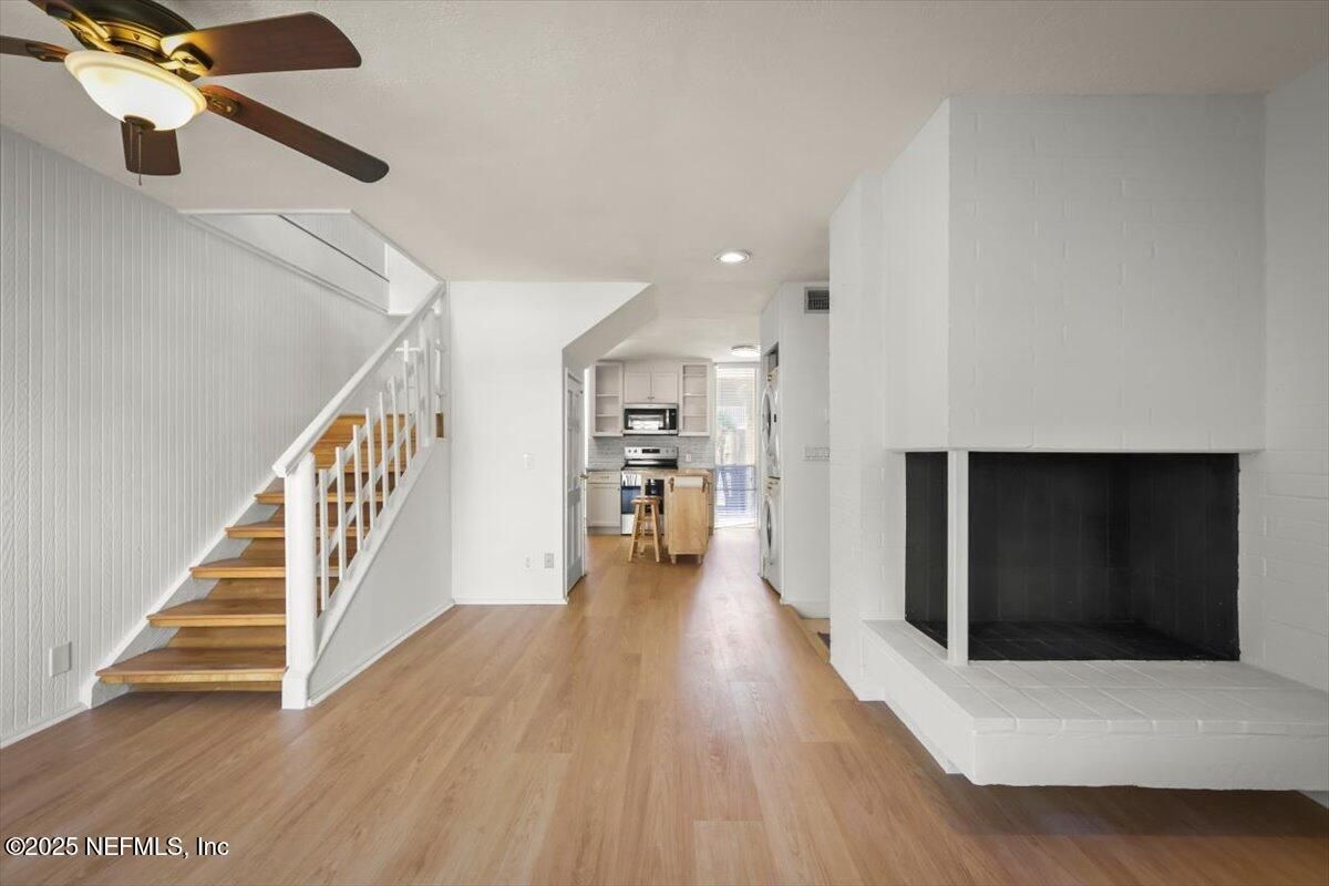 Fireplace, Interior, Kitchen, Recessed Lighting, Stainless Steel Appliances, Wood Texture Flooring