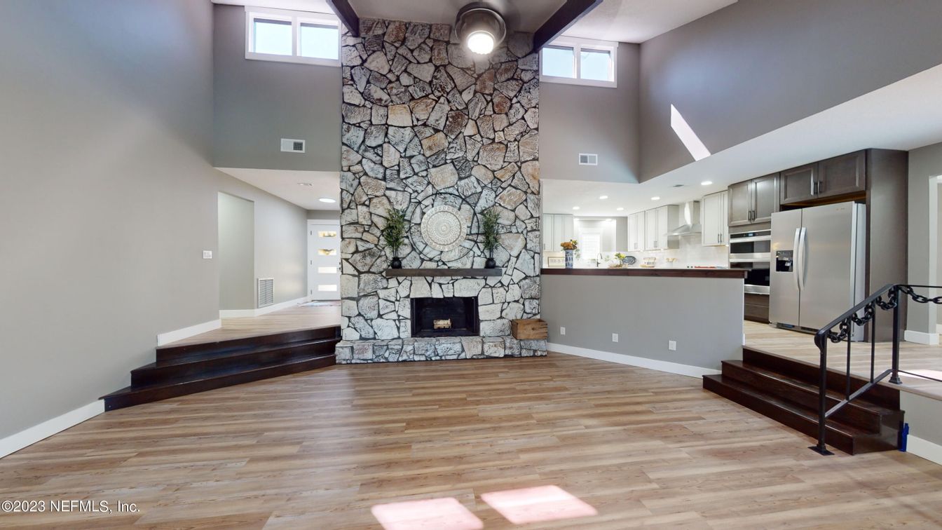 Fireplace, Interior, Kitchen, Recessed Lighting, Stainless Steel Appliances, Stone Walls, Wood Texture Flooring