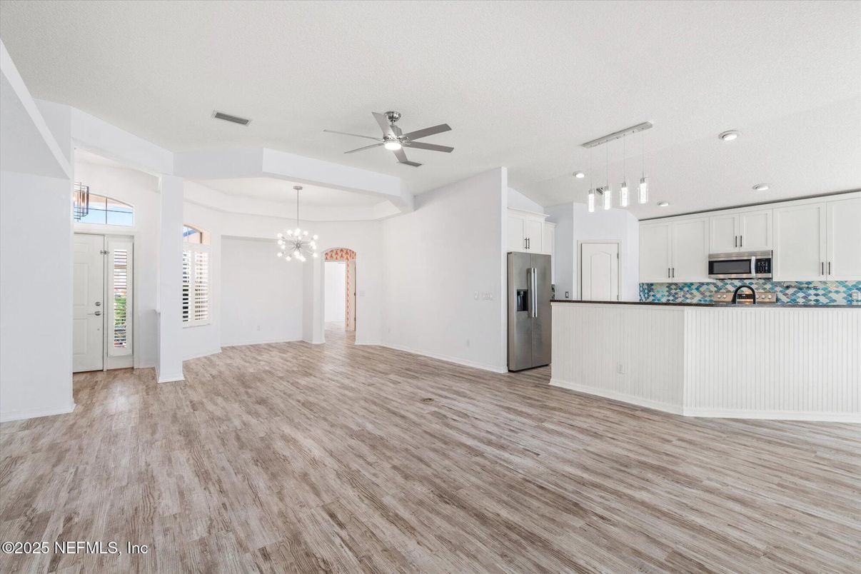 Chandelier, Empty room, Interior, Kitchen, Pendant Lights, Recessed Lighting, Stainless Steel Appliances, Wood Texture Flooring