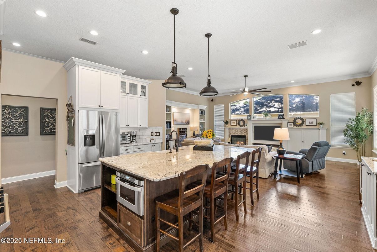 Fireplace, Interior, Kitchen, Living room, Pendant Lights, Recessed Lighting, Stainless Steel Appliances, Wood Texture Flooring