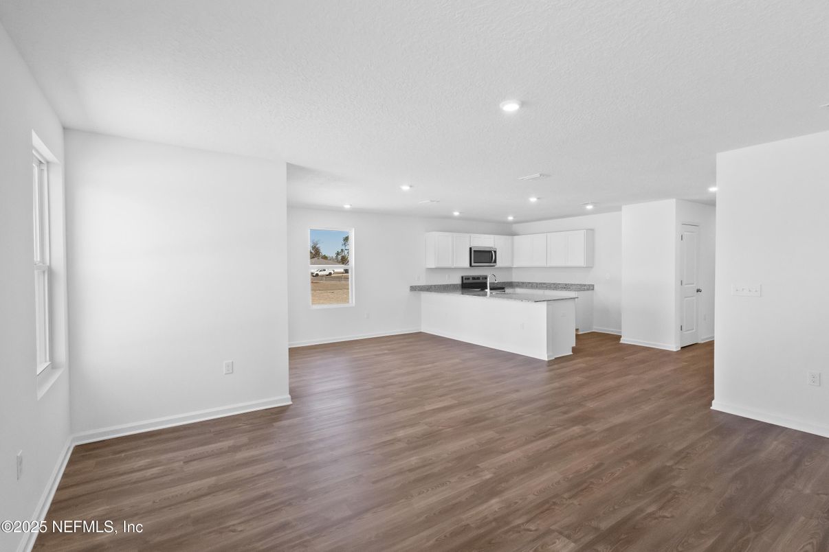 Empty room, Interior, Kitchen, Recessed Lighting, Stainless Steel Appliances, Wood Texture Flooring