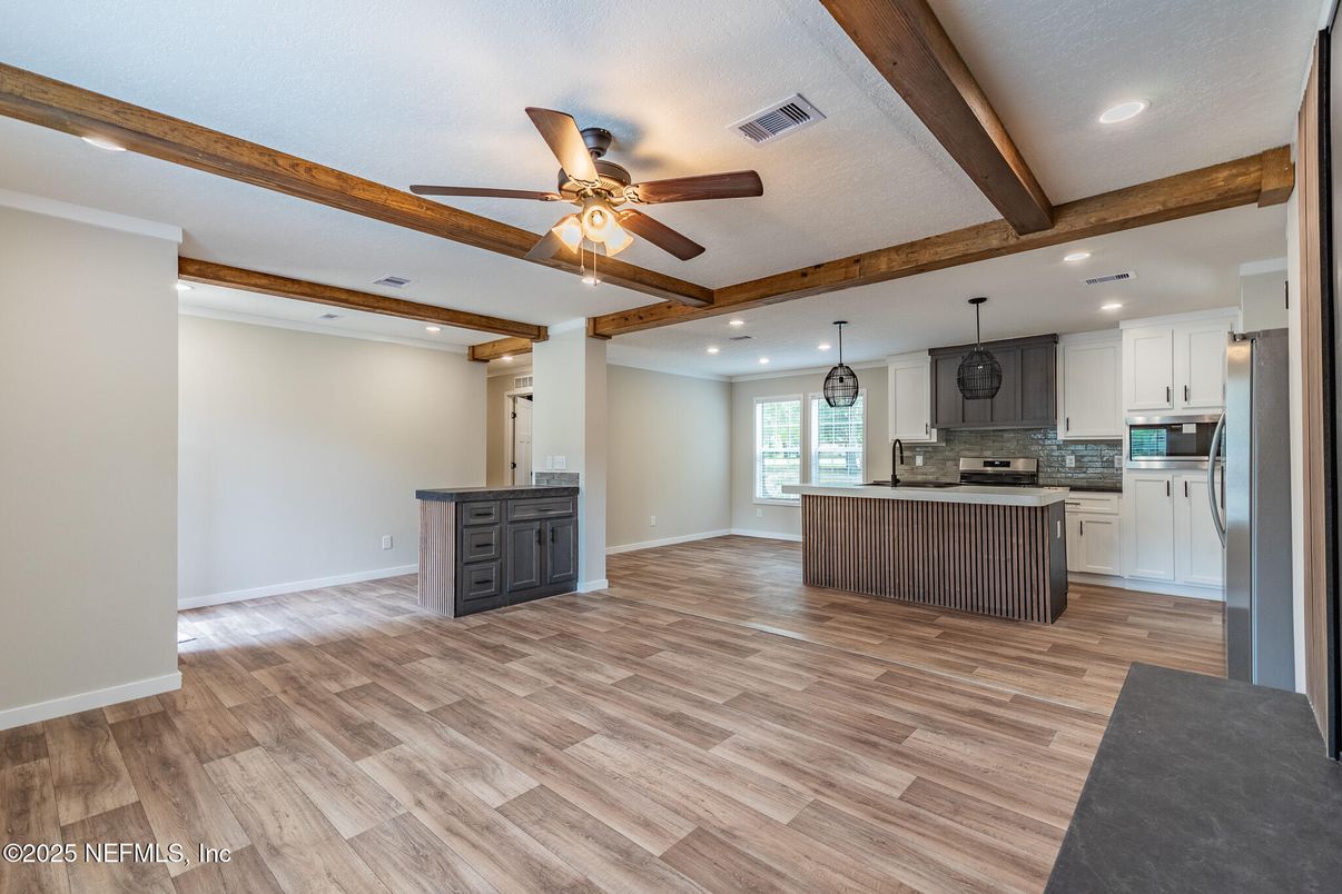 Empty room, Interior, Kitchen, Pendant Lights, Recessed Lighting, Stainless Steel Appliances, Wooden Beams, Wood Texture Flooring