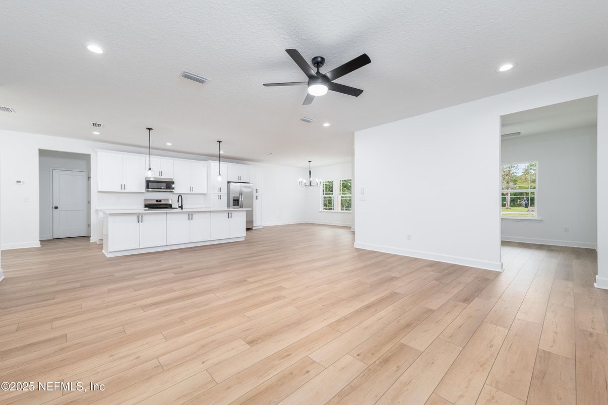 Empty room, Interior, Kitchen, Pendant Lights, Recessed Lighting, Stainless Steel Appliances, Wood Texture Flooring