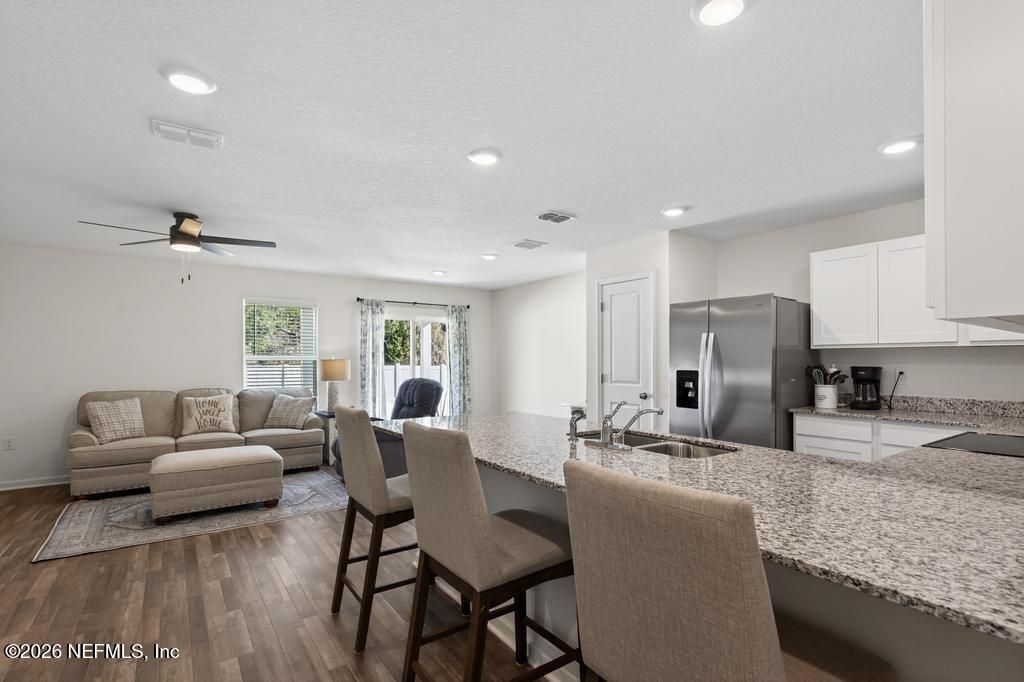 Dining room, Interior, Kitchen, Living room, Recessed Lighting, Stainless Steel Appliances, Wood Texture Flooring